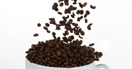 Coffee Beans Falling into a Cup against White Background