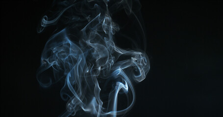 Smoke of Cigarette rising against Black Background