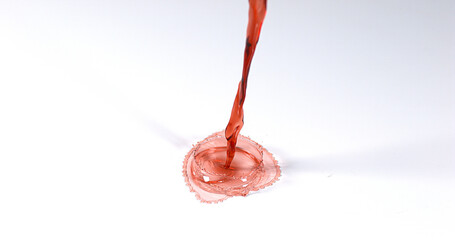 Red Wine being poured against White Background