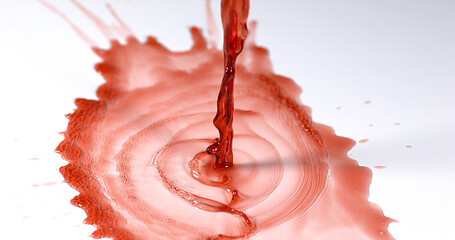 Red Wine being poured against White Background