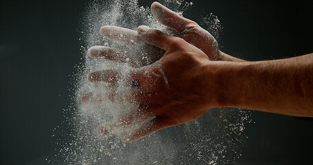 Hands of Man with Flour against black background