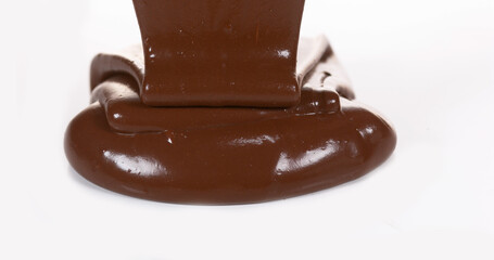 Chocolate Flowing on White Background