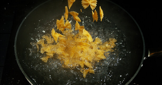 Pasta falling into boiling water