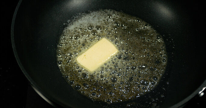 Butter that melts and crackles in a stove.