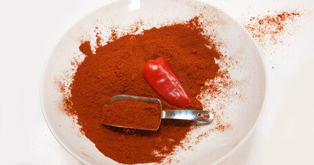 Paprika, capsicum annuum, falling into a bowl against White Background