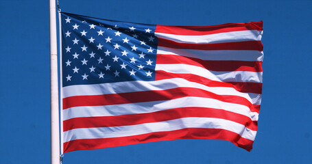 American Flag Waving in the Wind against blue sky