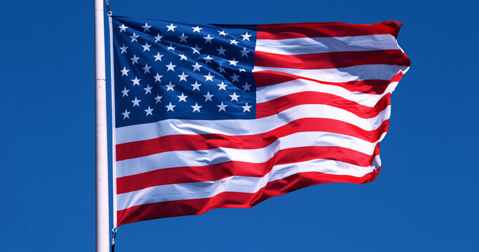 American Flag Waving in the Wind against blue sky