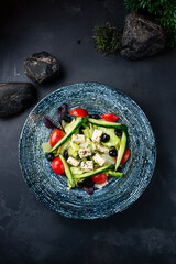 Greek salad of fresh cucumber, cherry tomatoes, lettuce, feta cheese, olives and basil.