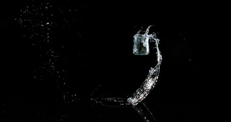Glass of Water Bouncing and Splashing on Black Background