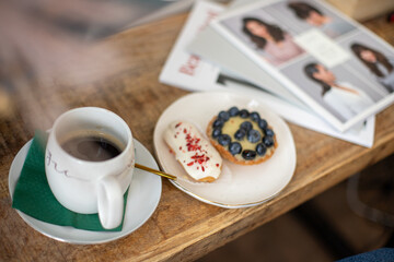cup of coffee, cakes and newspaper