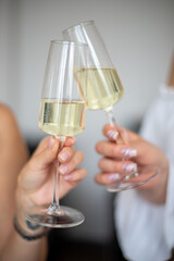 two hands holding glasses of champagne