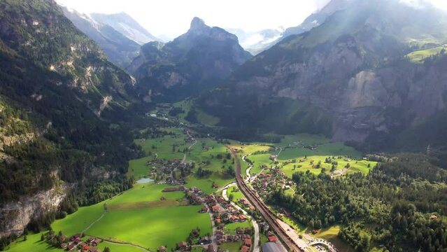 Swiss nature scenery. Kandersteg village with stunning valley surrouded by high Alps mountains. popular tourist ski resort. Canton Bern, Switzerland. aerial view