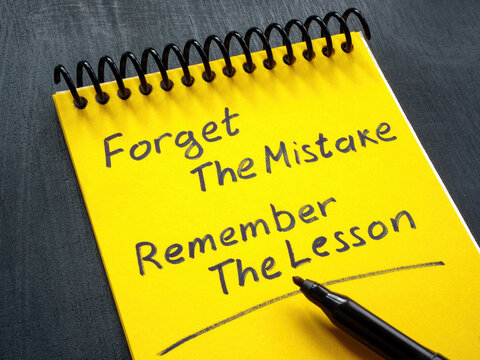 Notebook with motivation quote forget the mistake remember the lesson.