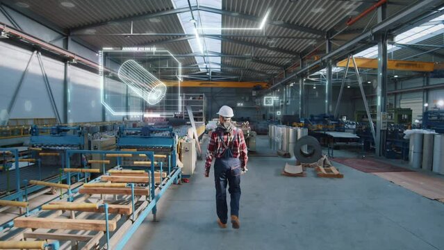 Digital visualization at the factory. Worker dressed uniform and protective helmet walking through construction equipment.