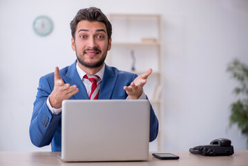 Young male employee working in the office