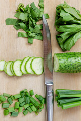 Sliced green vegetables on a cutting board. Top view.
