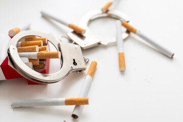 I am a hostage of smoking. Close up of broken cigarettes on ash tray. Near it cigarettes are...
