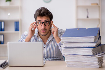 Fototapeta premium Young male employee working in the office