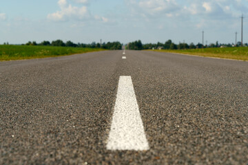 Automobile road with asphalt and framed in summer. Empty straight road.