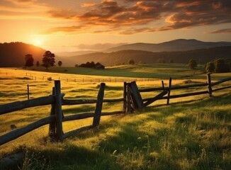 Fototapeta premium A rural landscape adorned with fields of verdant grass, harmonizing with the hues of a setting sun in the background.