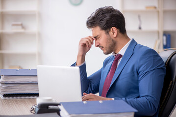 Young male employee working in the office