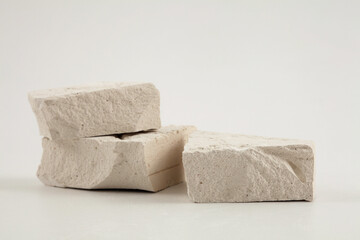 Stack white stones platform podium on gray light copy space background. Minimal empty display product presentation scene.