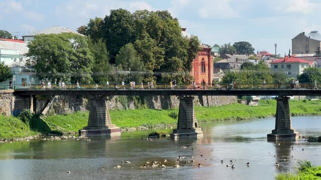 Uzhhorod Pedestrian Bridge at beautiful spring day. Bridge over the river Uzh in Uzhhorod, Transcarpathia.