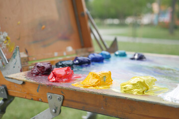 Colorful palette with oil painting and brushes