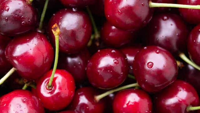 4K video with rotation. Top view. Box of fresh raw juicy red cherries. Concept of harvest, buying farm food at street market in Tbilisi. Showcase of fruit shop. Grocery store counter with vegetables.