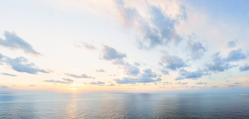 Calm dawn sea panoramic background. Morning blue sky with colorful clouds - pastel neutral pink,...