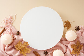 Experience the serene comfort of fall's embrace at home. Top view of pink plaid, candles, cinnamon sticks, acorns, anise, fallen autumn leaves on pastel beige background with blank circle for promo