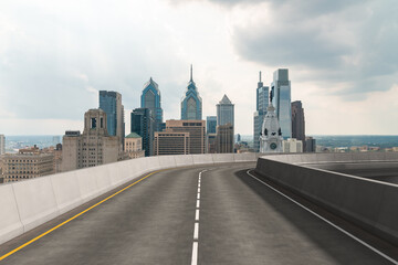 Empty urban asphalt road exterior with city buildings background. New modern highway concrete construction. Concept way to success. Transportation logistic industry fast delivery. Philadelphia. USA.