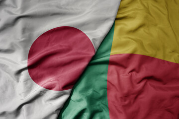 big waving national colorful flag of japan and national flag of benin .