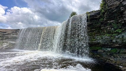 A beautiful big waterfall in Estonia on a clear sunny day