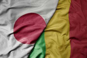 big waving national colorful flag of japan and national flag of mali .
