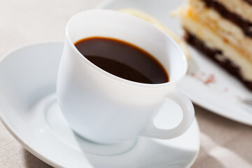 Closeup cup of black coffee with chocolate dessert