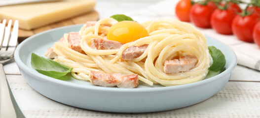 Delicious pasta Carbonara with egg yolk on white wooden table, closeup. Banner design