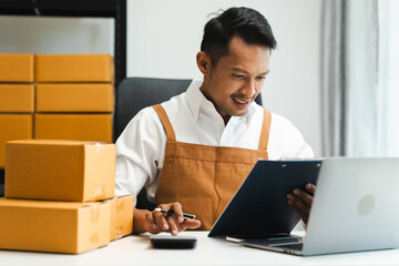 Startup SME small business entrepreneur of freelance Asian Indian man wearing apron prepare parcel...