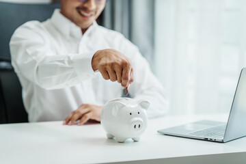 Piggy bank, Asian Indian male market researchers specialize in collecting initiative analyst, monitor marketing activities, analyze published data, evaluate past performance of product, service sales