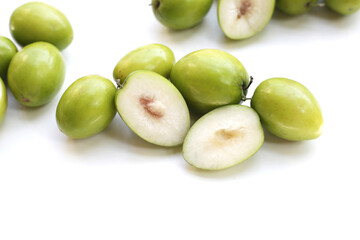 Green jujube fruits on white background.