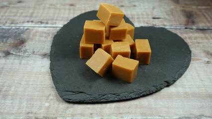 Clotted cream fudge, delicious sweet candy treat on a black slate heart