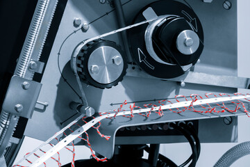 Fragment of the conveyor of sticking labeling machine. Abstract industrial