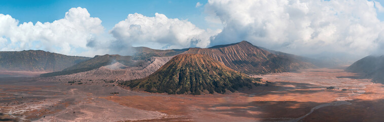 Superpano photo of Bromo volcano with cloudy blue sky. Indonesian national park, mount Semeru view