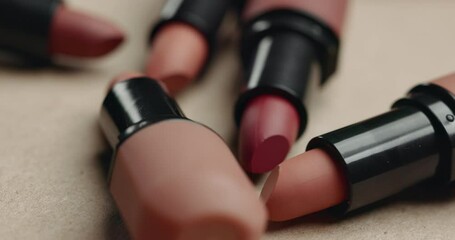Lipstick, makeup product and cosmetics fall on table, beauty and cosmetology tools drop on background on vanity in salon. Self care, lip gloss and closeup for aesthetic and application in bathroom