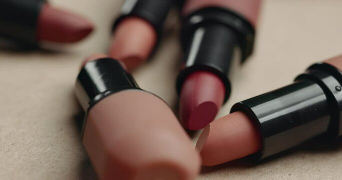 Lipstick, makeup product and cosmetics fall on table, beauty and cosmetology tools drop on background on vanity in salon. Self care, lip gloss and closeup for aesthetic and application in bathroom