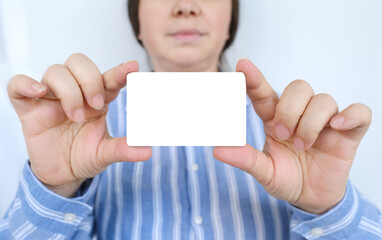 woman holds empty blue card, shows empty mock up, blank space, pay attention to important information, woman at work