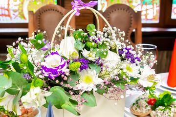 Beautiful roses bouquet flowers composition on holiday table setting,festive event,dishes,snacks.Spring floral romantic background.Flower shop,florist design,Womens, Valentines,Mother day,birthday.