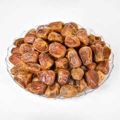 Dried Dates in a bowl isolated white background.