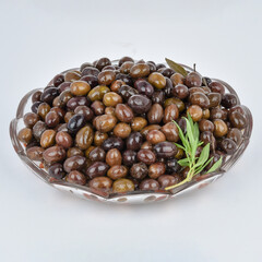 Fresh Black olives pickled isolated in glass bowl