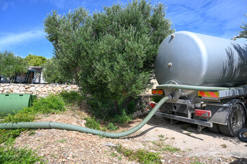 Vacuum tanker used to collect sewage. A tanker truck is emptying a septic tank. Sewage cleaning...